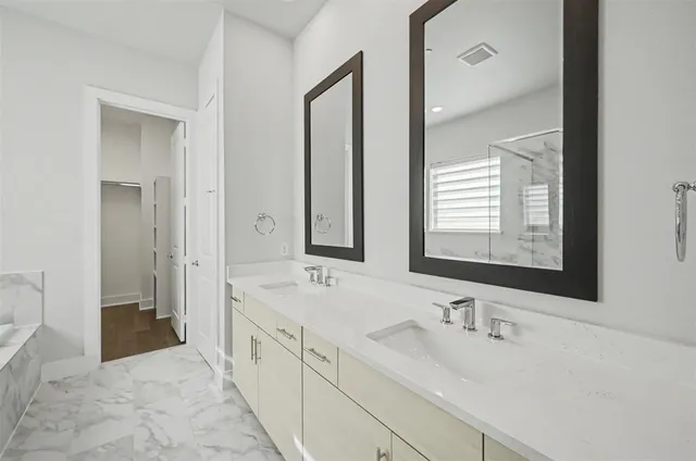 a bathroom with a double vanity sink mirror and double