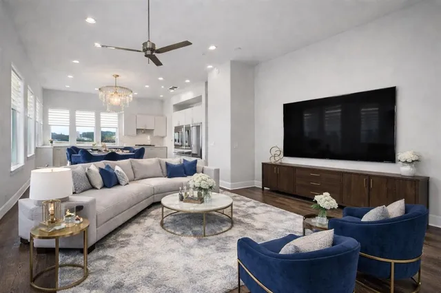 a living room with furniture kitchen and a fireplace