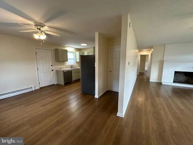 a view of a kitchen with wooden floor and a sink