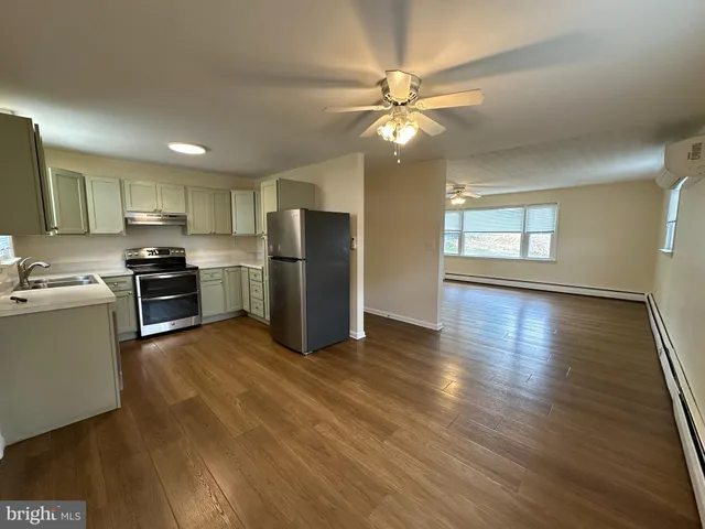 a kitchen with stainless steel appliances a refrigerator sink and stove