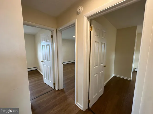 a view of a hallway with wooden floor