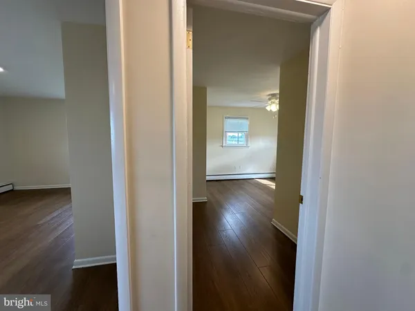 a view of a hallway with wooden floor