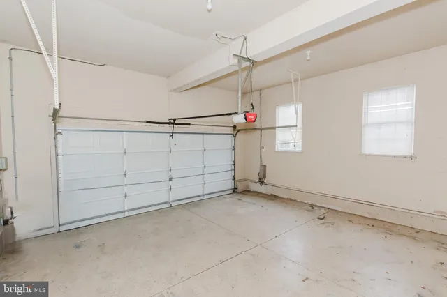 a view of a big room with windows and chandelier
