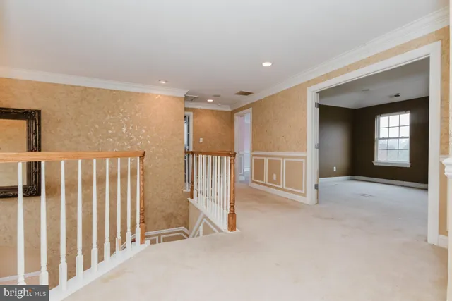 a view of a house with a yard and a large tree