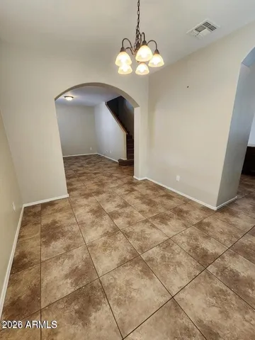 a view of an empty room with a chandelier