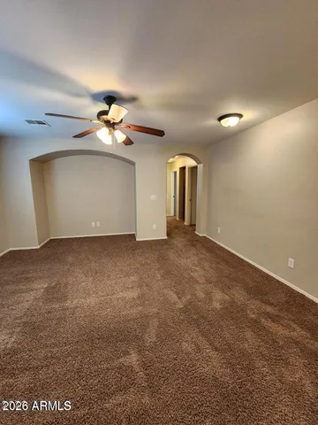 a view of a room with a ceiling fan