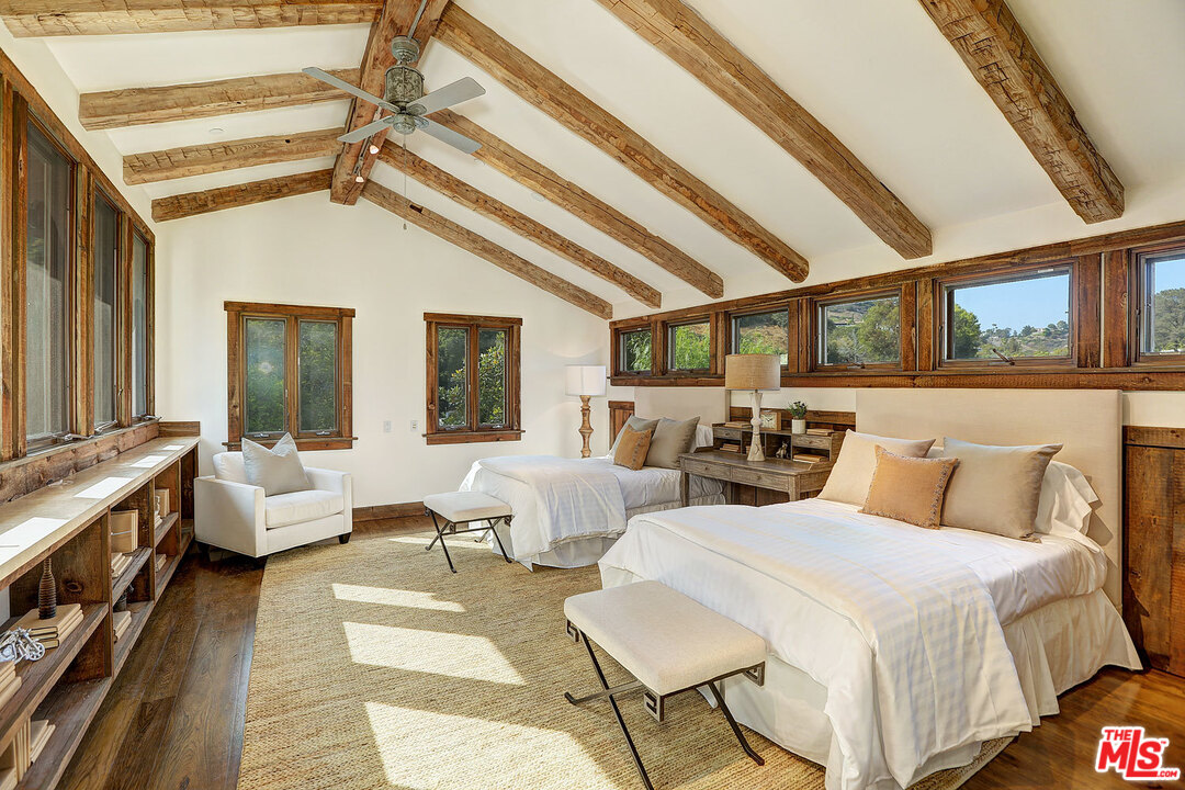 10960 Bellagio Road Los Angeles, CA 90077 - Photo 15 of 22 a spacious bedroom with two beds and large windows