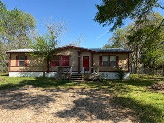 215 Parrish Street New Waverly, TX 77358 - Photo 1 of 12 a view of a house with a yard