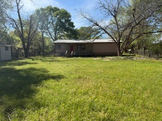 215 Parrish Street New Waverly, TX 77358 - Photo 12 of 12 a backyard of a house with yard and trampoline