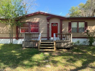 215 Parrish Street New Waverly, TX 77358 - Photo 2 of 12 a front view of a house with a yard