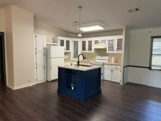 215 Parrish Street New Waverly, TX 77358 - Photo 3 of 12 a kitchen with a sink cabinets and wooden floor