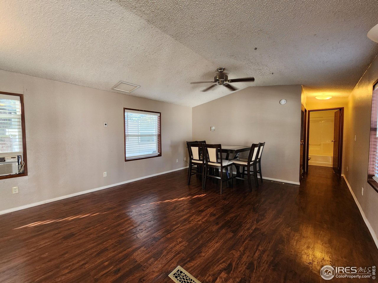 5000 Butte Street, Unit 208 Boulder, CO 80301 - Photo 11 of 37 a view of a room with wooden floor and a ceiling fan