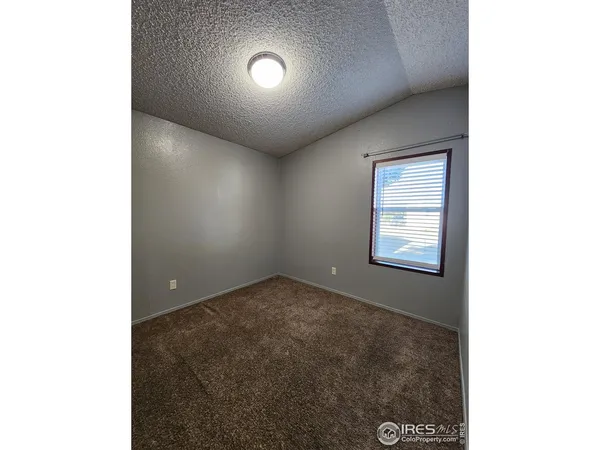 an empty room with a empty space and windows