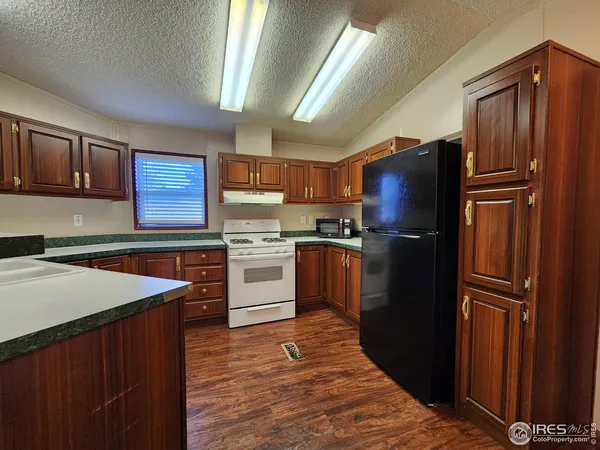 a kitchen with granite countertop stainless steel appliances and wooden cabinets