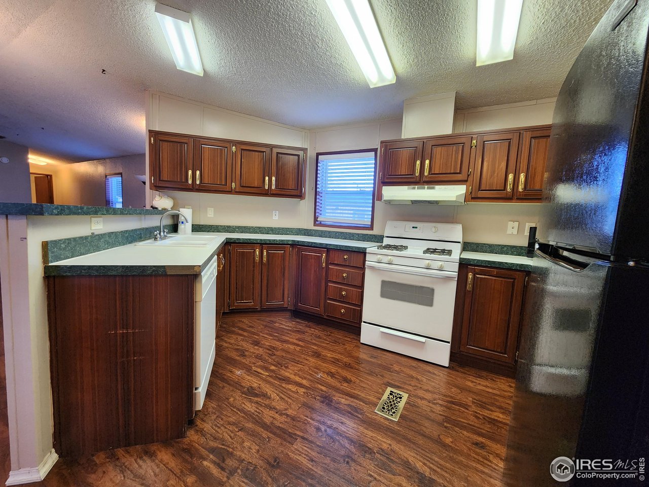 5000 Butte Street, Unit 208 Boulder, CO 80301 - Photo 6 of 37 a kitchen with stainless steel appliances granite countertop a stove a sink and a refrigerator