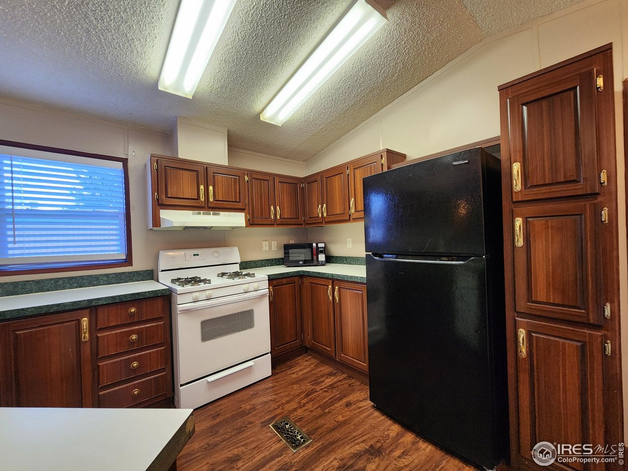 5000 Butte Street, Unit 208 Boulder, CO 80301 - Photo 9 of 37 a kitchen with stainless steel appliances granite countertop a refrigerator stove and sink