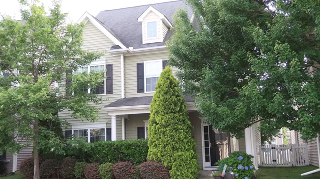 a house that has a tree in front of it