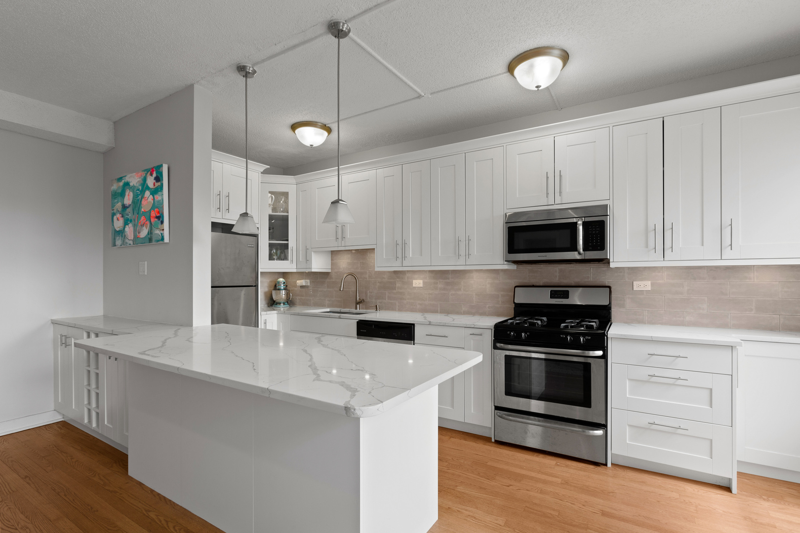 725 West Sheridan Road, Unit 506 Chicago, IL 60613 - Photo 4 of 14 a kitchen with stainless steel appliances granite countertop a stove and a refrigerator