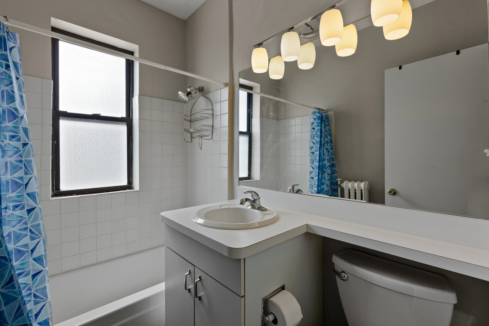 725 West Sheridan Road, Unit 506 Chicago, IL 60613 - Photo 6 of 14 a bathroom with a sink a vanity and a mirror