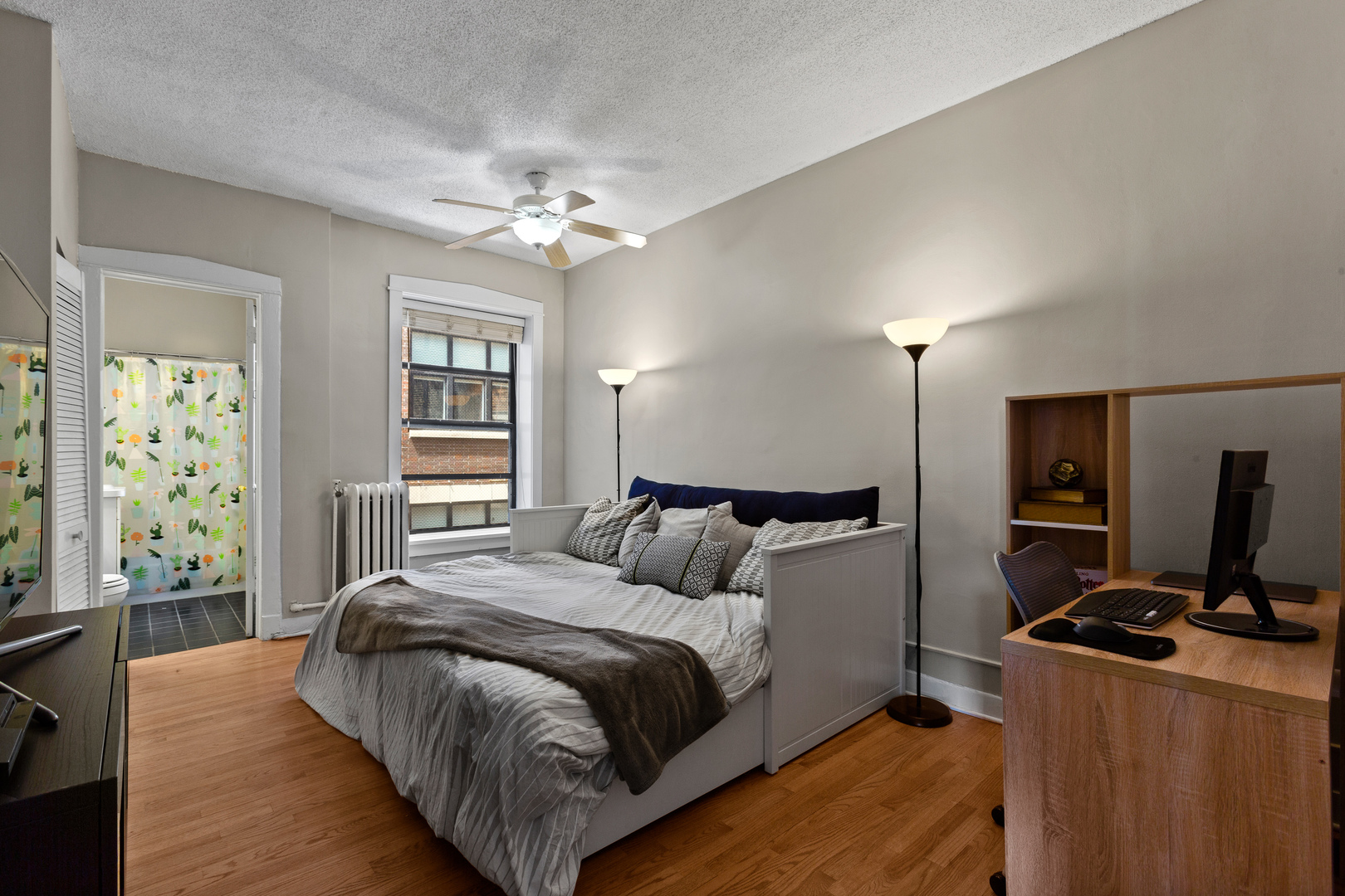 725 West Sheridan Road, Unit 506 Chicago, IL 60613 - Photo 7 of 14 a bedroom with a bed and a chandelier