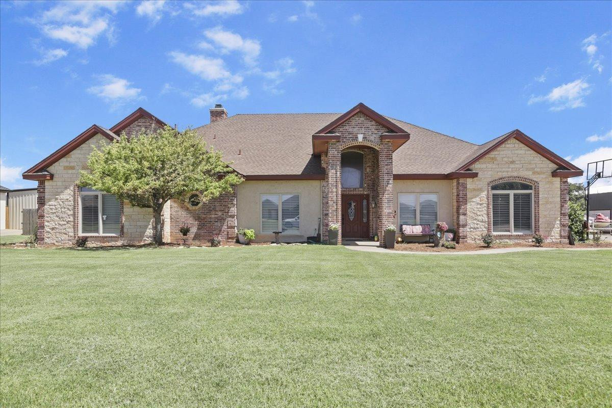 6304 County Road 7475 Lubbock, TX 79424 - Photo 1 of 28 a front view of a house with a garden and porch