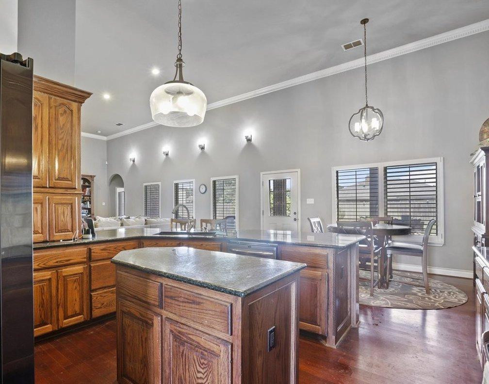 6304 County Road 7475 Lubbock, TX 79424 - Photo 11 of 28 a kitchen with center island and wooden floors