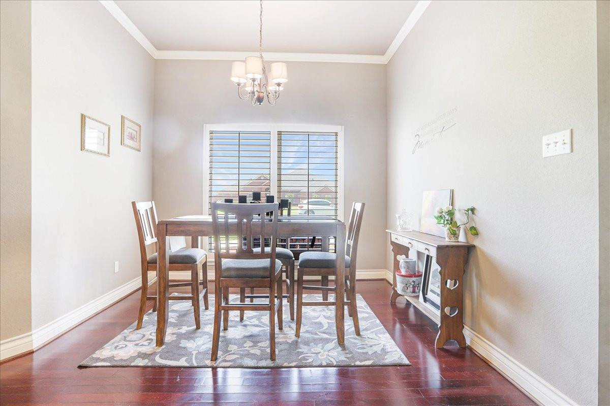 6304 County Road 7475 Lubbock, TX 79424 - Photo 13 of 28 a view of a dining room with furniture window and wooden floor