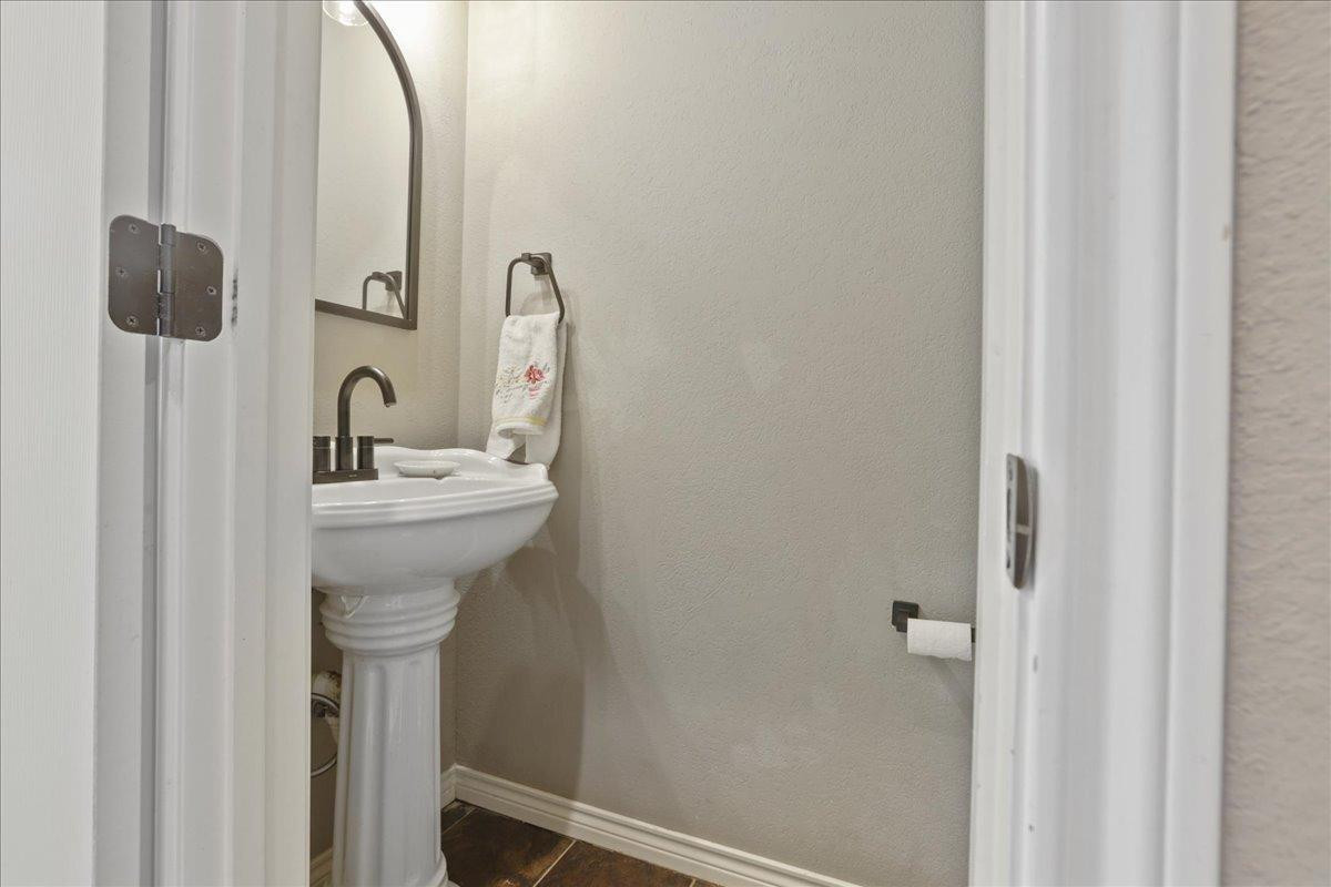 6304 County Road 7475 Lubbock, TX 79424 - Photo 15 of 28 a bathroom with a sink and mirror
