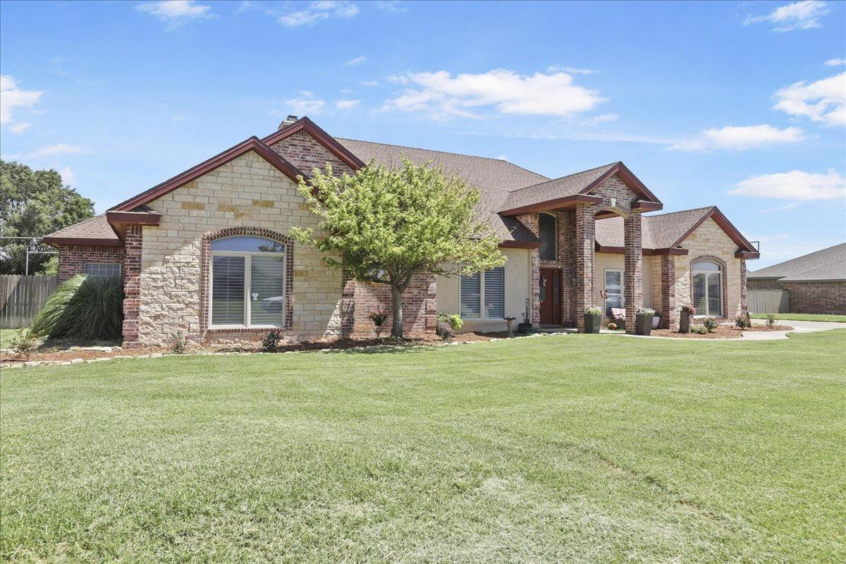 6304 County Road 7475 Lubbock, TX 79424 - Photo 2 of 28 a front view of a house with a garden