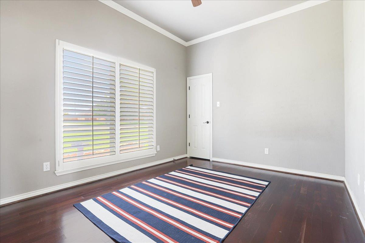 6304 County Road 7475 Lubbock, TX 79424 - Photo 22 of 28 a view of an empty room with a window and wooden floor