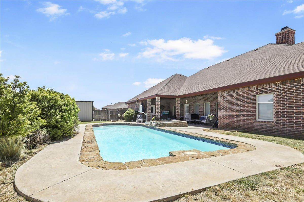 6304 County Road 7475 Lubbock, TX 79424 - Photo 26 of 28 a view of a house with swimming pool and sitting area