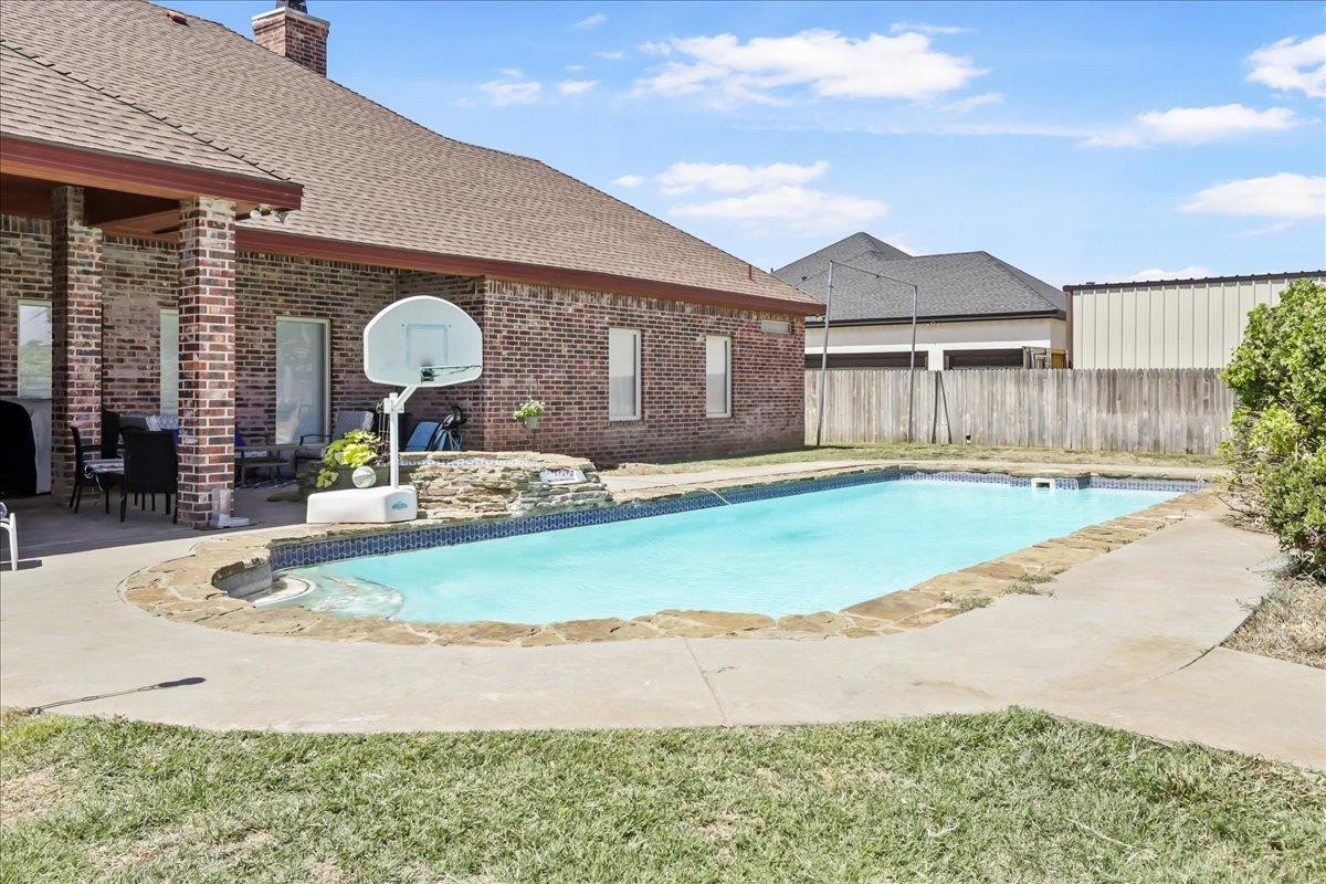 6304 County Road 7475 Lubbock, TX 79424 - Photo 27 of 28 a front view of a house with garden and patio