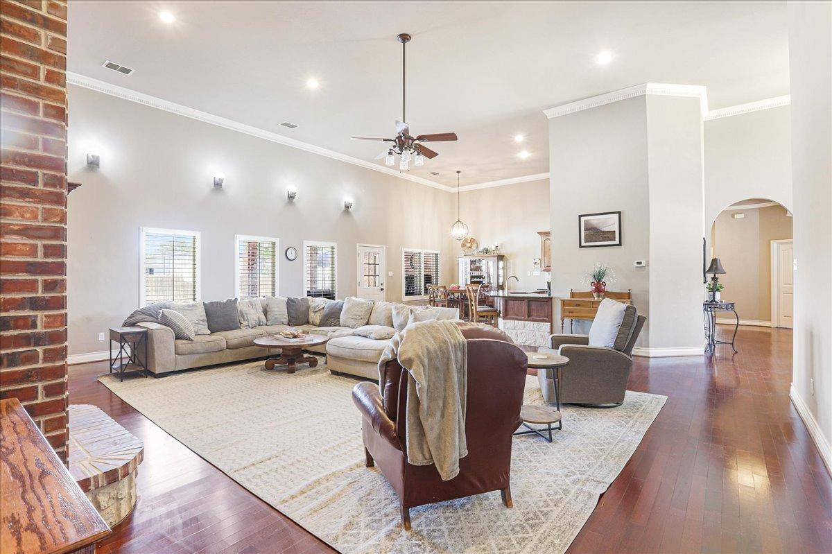 6304 County Road 7475 Lubbock, TX 79424 - Photo 6 of 28 a living room with lots of furniture and a chandelier