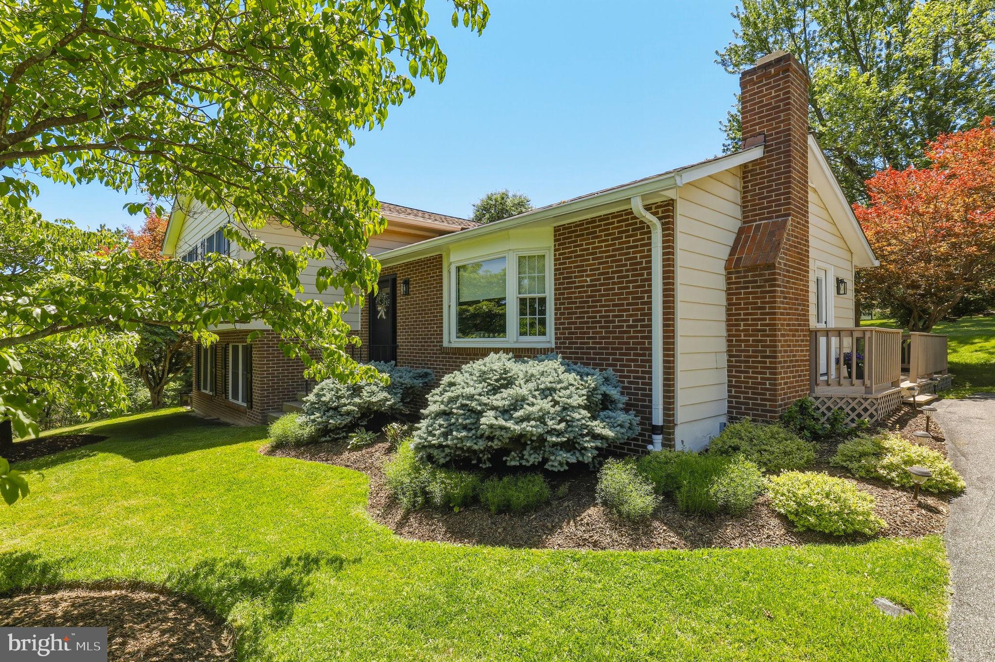 6336 Boyers Mill Road New Market, MD 21774 - Photo 2 of 49 a front view of a house with garden