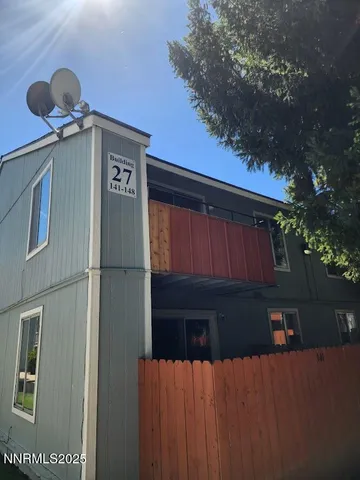 a view of a house with wooden fence