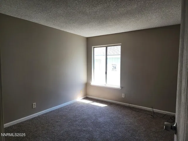 a view of an empty room with closet area