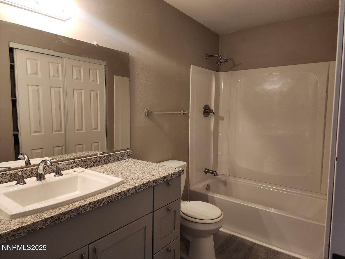 4604 Neil Road, Unit 142 Reno, NV 89502 - Photo 18 of 23 a bathroom with a granite countertop sink toilet and shower