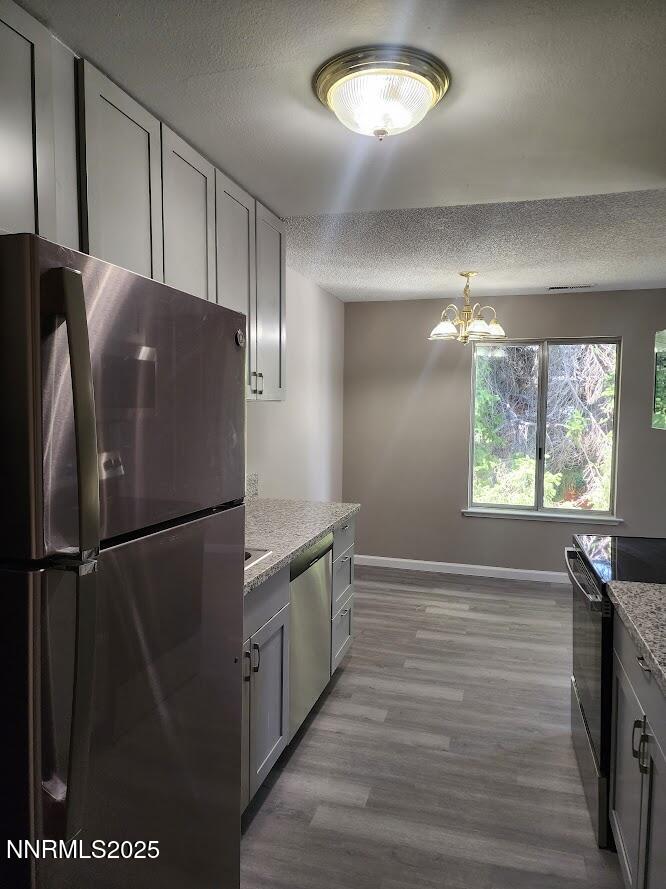 4604 Neil Road, Unit 142 Reno, NV 89502 - Photo 3 of 23 a view of a refrigerator in kitchen and wooden floor
