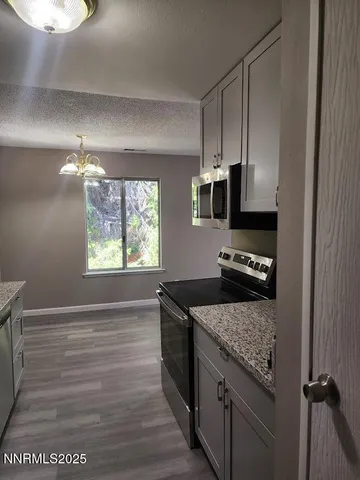 a kitchen with a stove and a refrigerator