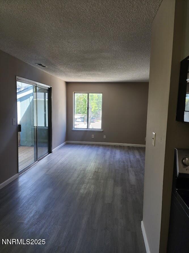 4604 Neil Road, Unit 142 Reno, NV 89502 - Photo 8 of 23 an empty room with wooden floor and windows