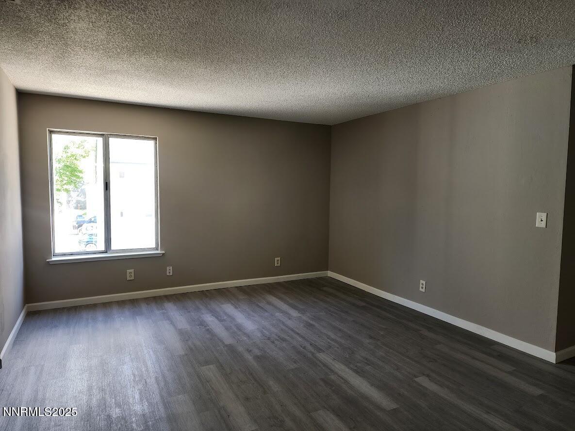 4604 Neil Road, Unit 142 Reno, NV 89502 - Photo 9 of 23 an empty room with wooden floor and windows