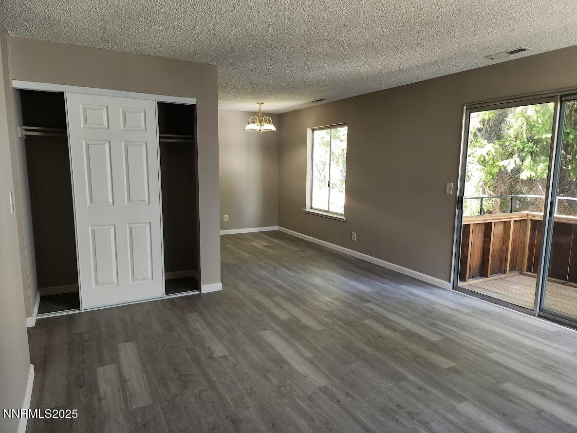 4604 Neil Road, Unit 142 Reno, NV 89502 - Photo 10 of 23 an empty room with wooden floor and windows