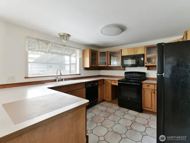 a kitchen with stainless steel appliances a stove sink and microwave