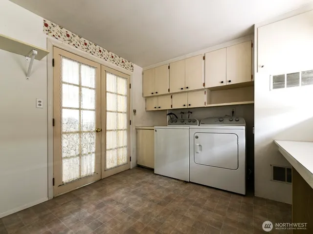 a kitchen with white cabinets and white appliances