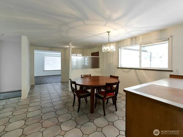a view of a dining room with furniture and window