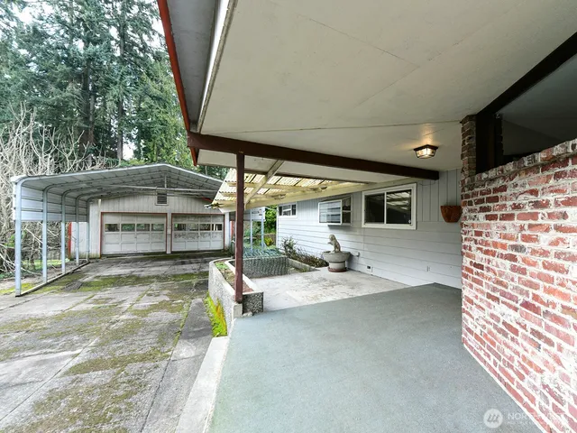 a view of a house with backyard porch and sitting area