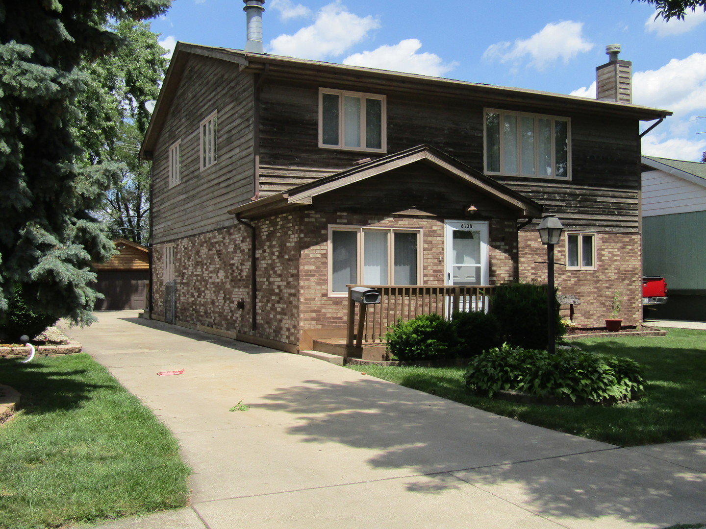 6138 Birmingham Street Chicago Ridge, IL 60415 - Photo 1 of 26 a front view of a house with a garden
