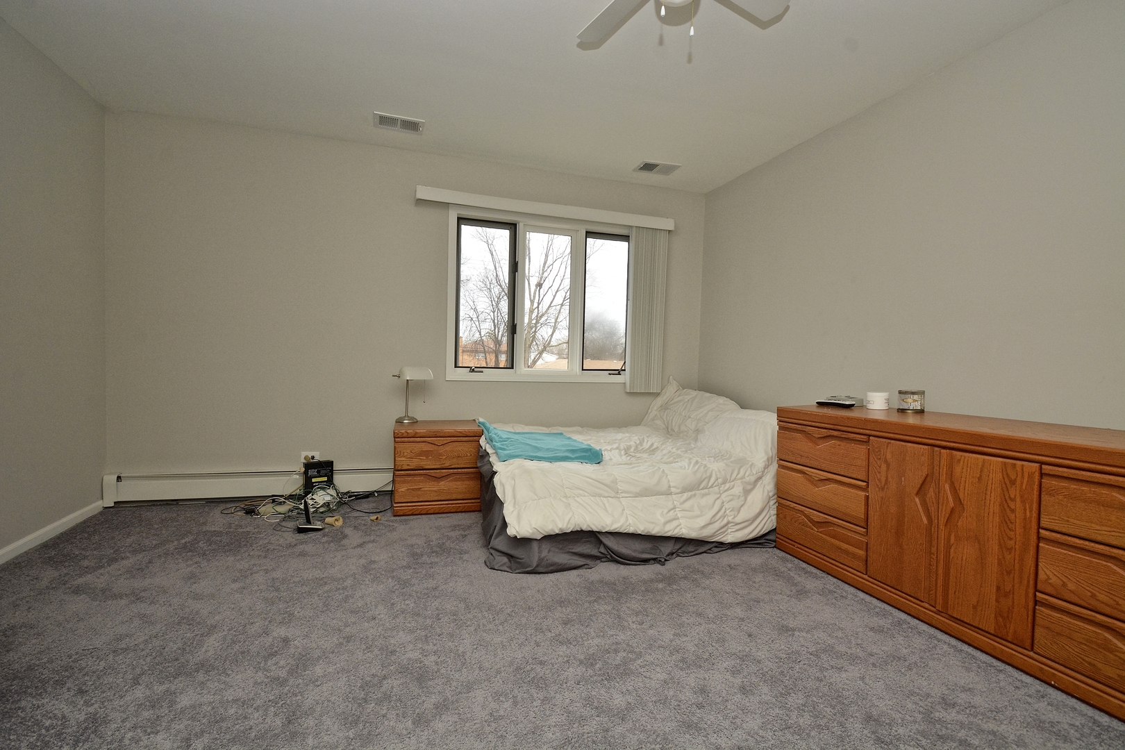 6138 Birmingham Street Chicago Ridge, IL 60415 - Photo 18 of 26 a spacious bedroom with a bed and a dresser