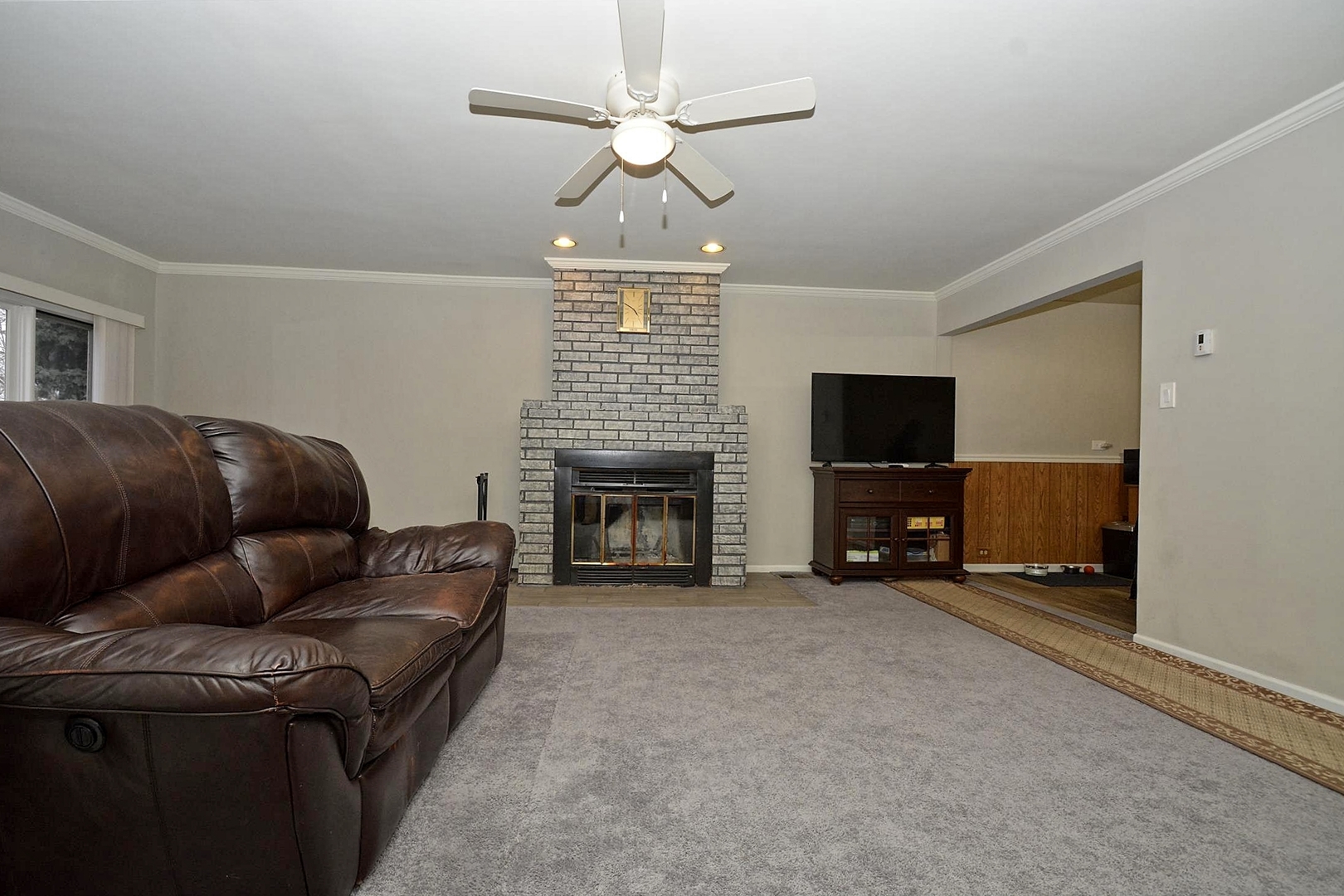6138 Birmingham Street Chicago Ridge, IL 60415 - Photo 3 of 26 a living room with furniture a fireplace and a flat screen tv