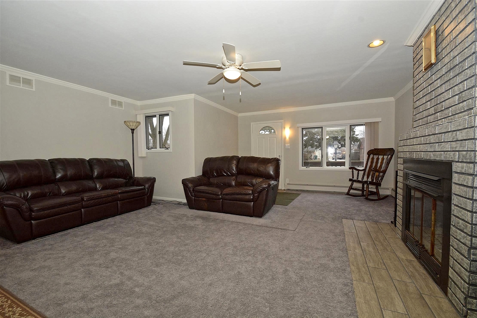 6138 Birmingham Street Chicago Ridge, IL 60415 - Photo 4 of 26 a living room with furniture and a fireplace
